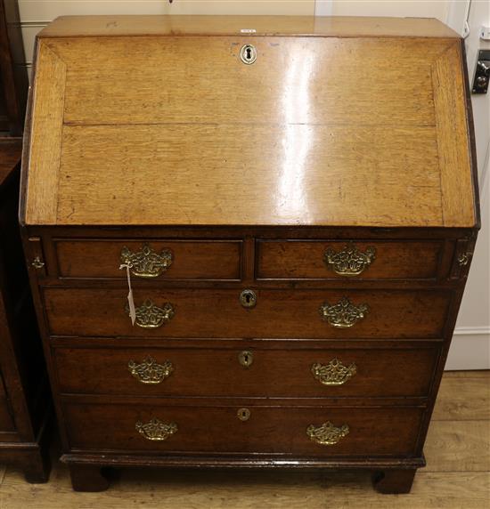 A George III oak bureau, W.91cm